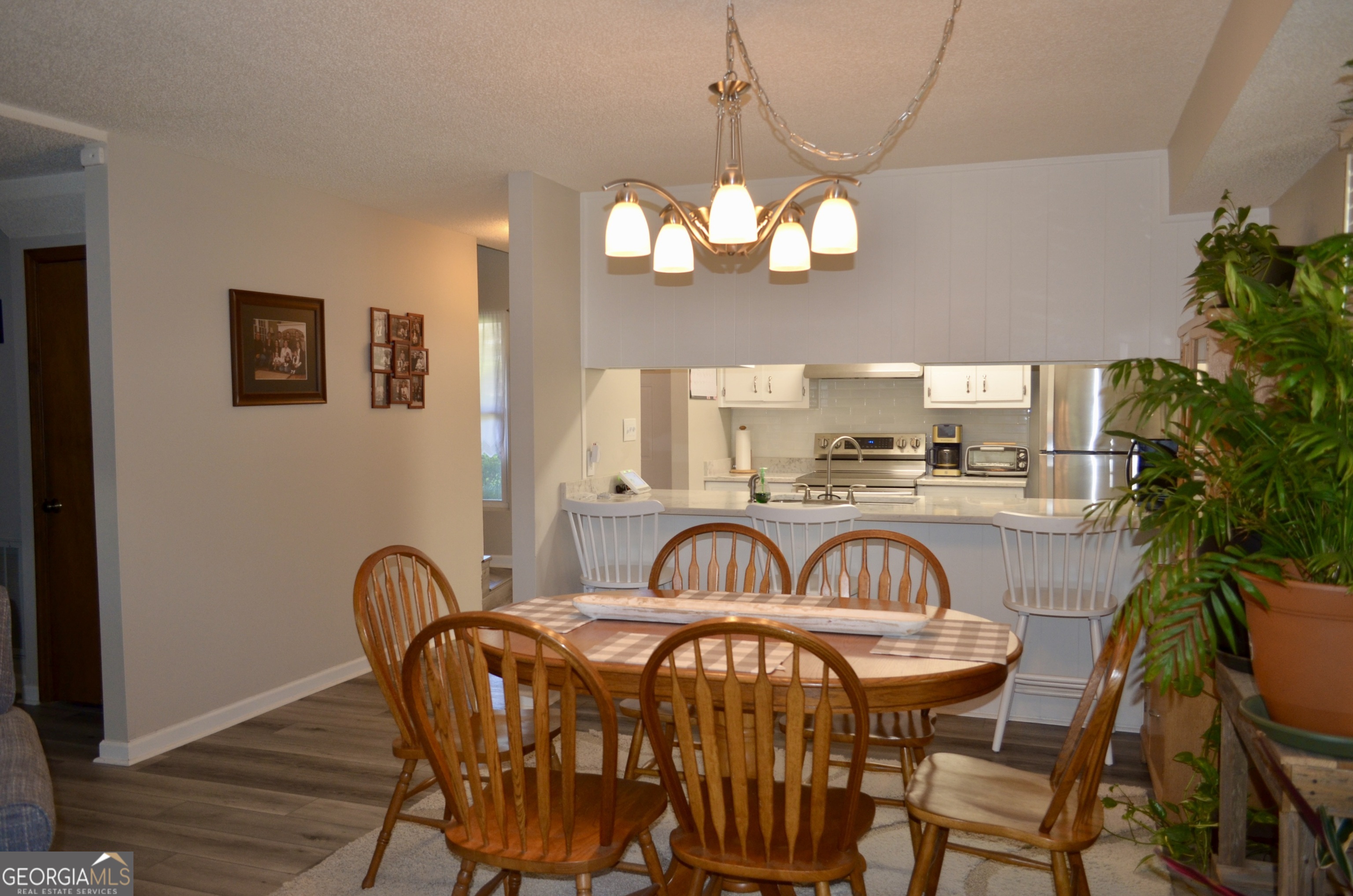 116 Elk Run Warner Robins, GA 31088 - Photo 6 of 43 a view of a dining room with furniture wooden floor and chandelier