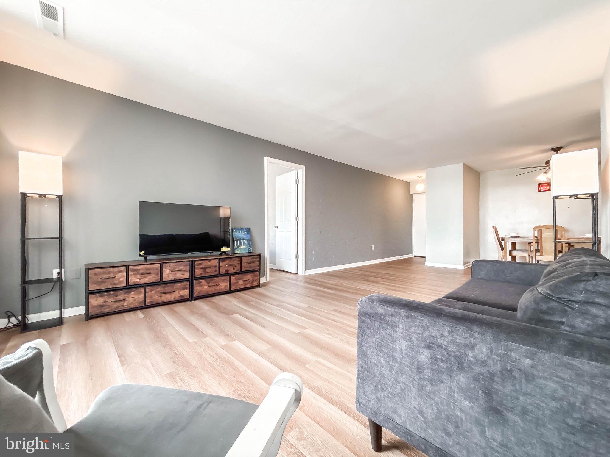 130 Slade Avenue, Unit 414 Baltimore, MD 21208 - Photo 6 of 48 a bedroom with a bed and a flat screen television