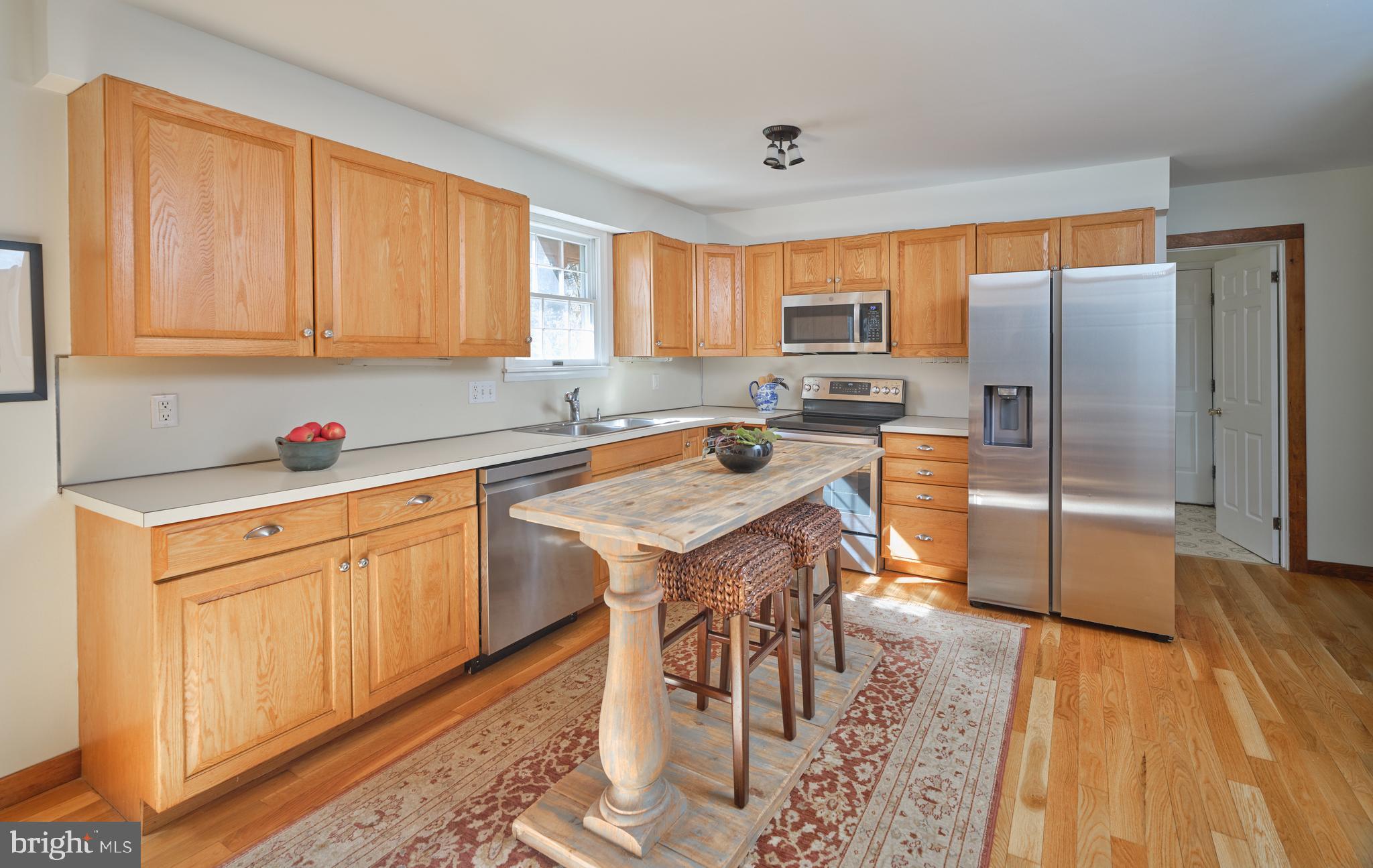 6724 Upper York Road New Hope, PA 18938 - Photo 12 of 40 a kitchen with stainless steel appliances granite countertop a refrigerator a sink dishwasher a stove with wooden cabinets and wooden floor