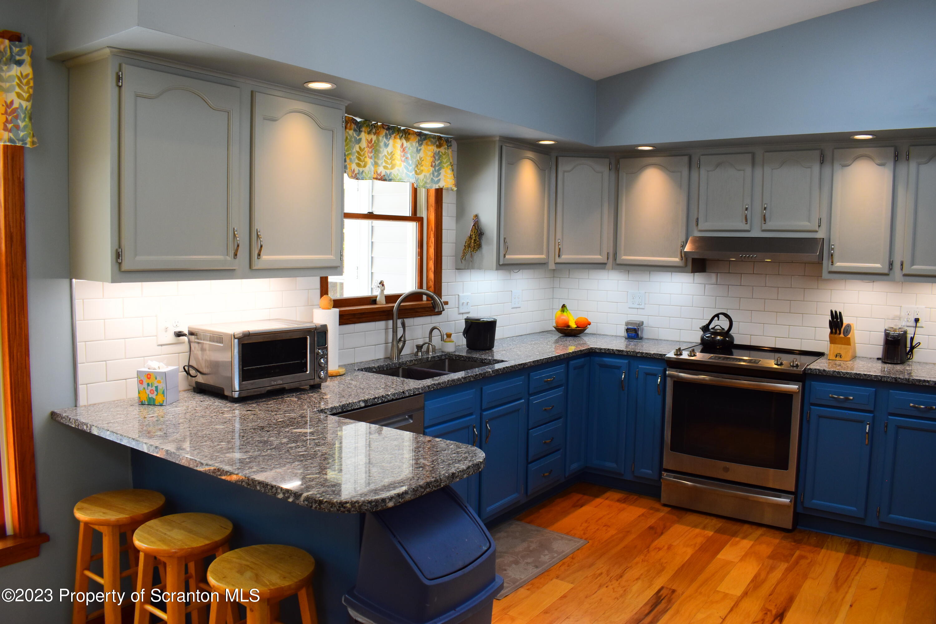 510 Hawranick Road Brackney, PA 18812 - Photo 13 of 76 a kitchen with granite countertop a stove a sink dishwasher and cabinets with wooden floor
