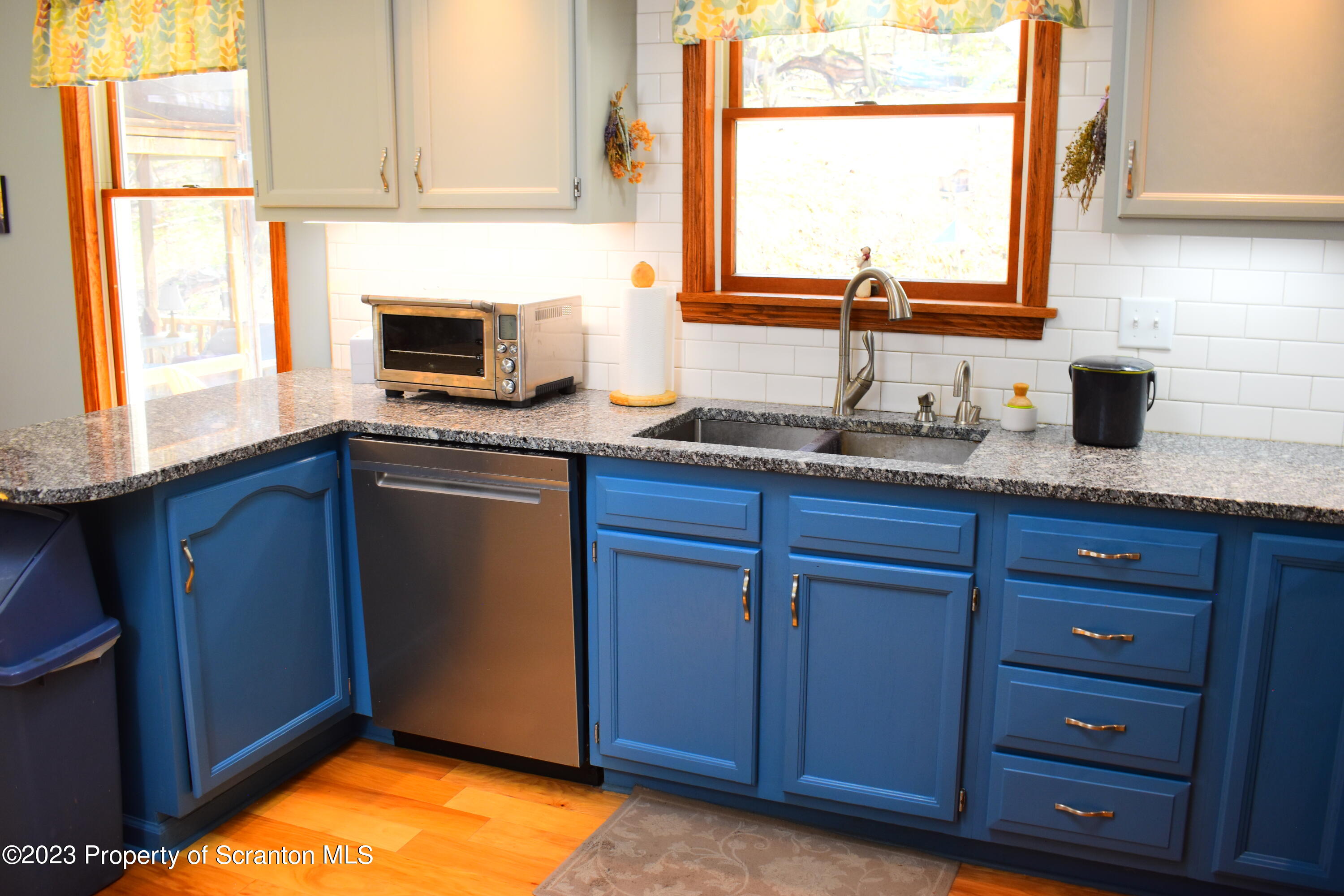 510 Hawranick Road Brackney, PA 18812 - Photo 9 of 76 a kitchen with granite countertop stainless steel appliances a sink window and cabinets
