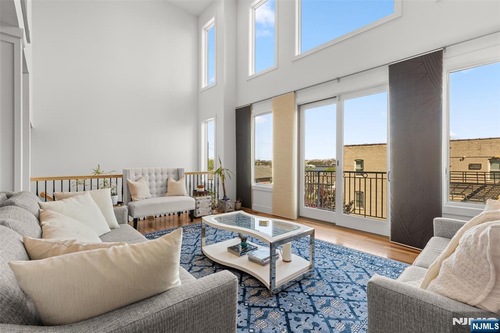 7 Oakdene Terrace, Unit 7 Edgewater, NJ 07020 - Photo 3 of 30 a living room with furniture and a floor to ceiling window