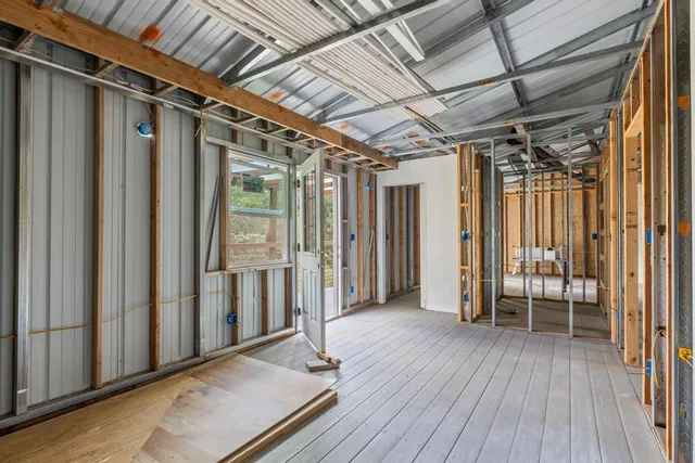 a view of an entryway with wooden floor and door