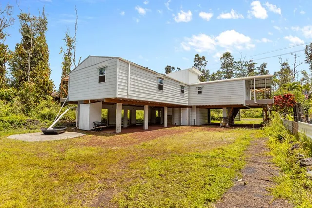 a view of a house with swimming pool and sitting area