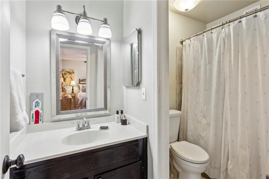 162 Lablanc Way Northwest Atlanta, GA 30327 - Photo 15 of 22 a bathroom with a sink vanity mirror and toilet
