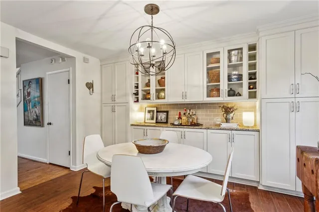 a view of a dining room with furniture wooden floor and chandelier