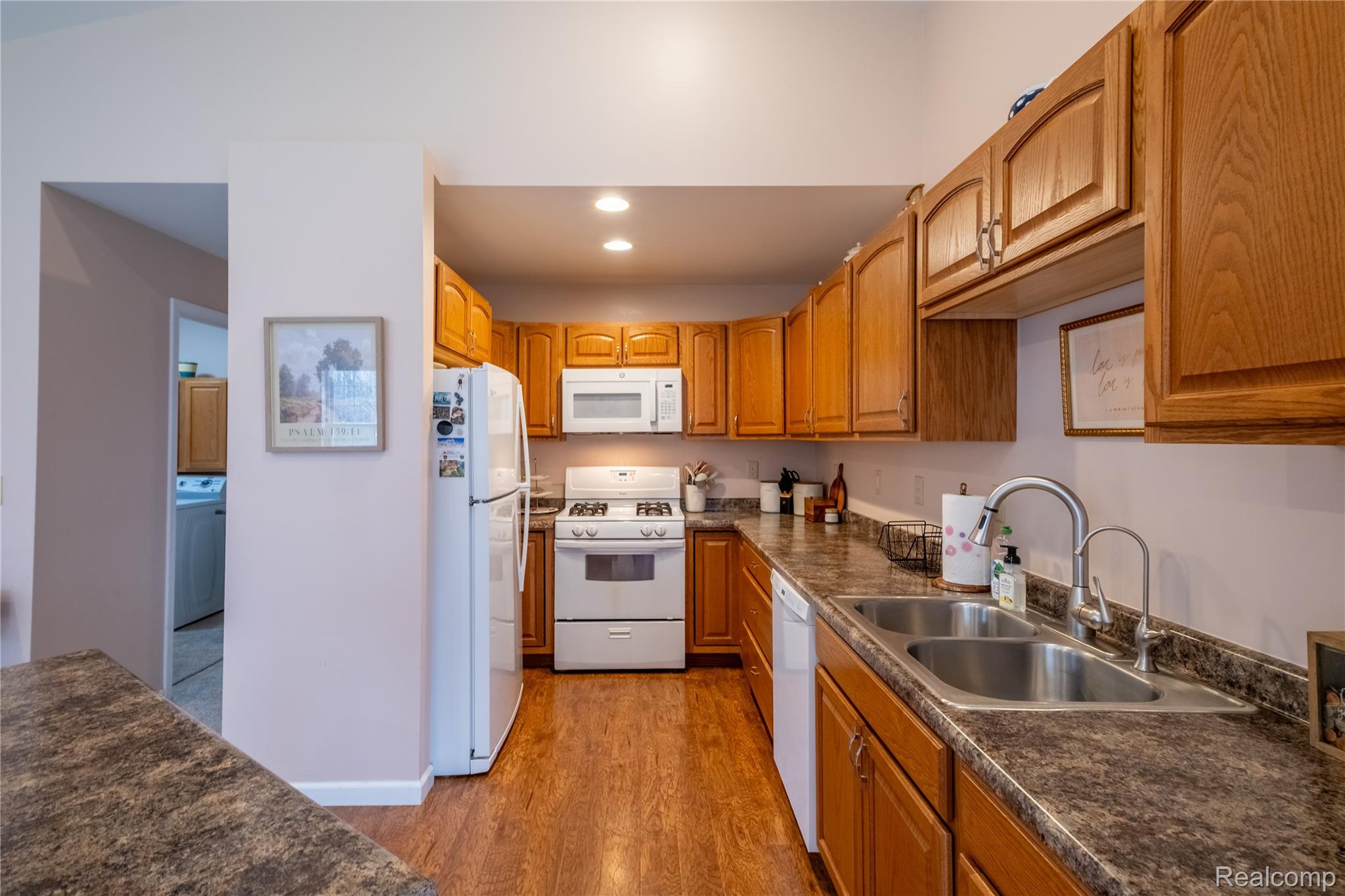 4210 Evans Road Holly, MI 48442 - Photo 10 of 23 Kitchen with white appliances, dark countertops, wood finish cabinets, recessed lighting, and light wood finished floors