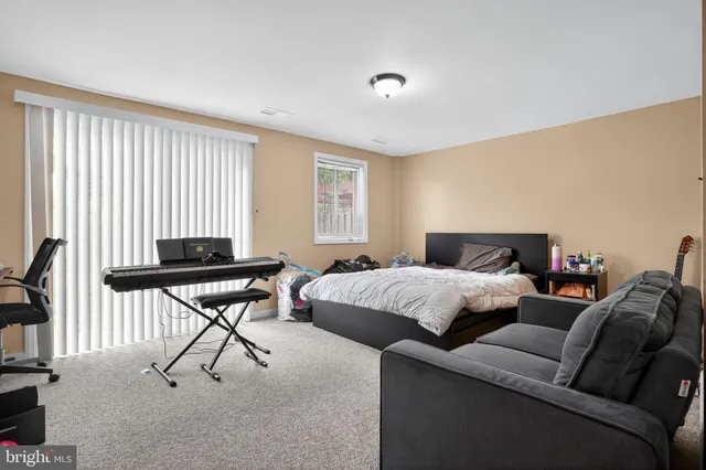 a bedroom with furniture and a window