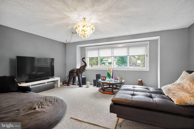 a bedroom with bed and a chandelier