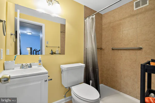 a white toilet sitting next to a bathroom sink