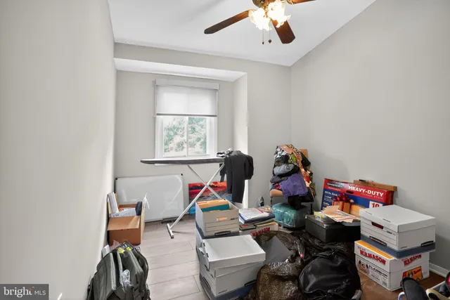 a living room with furniture a air conditioner vent and a window
