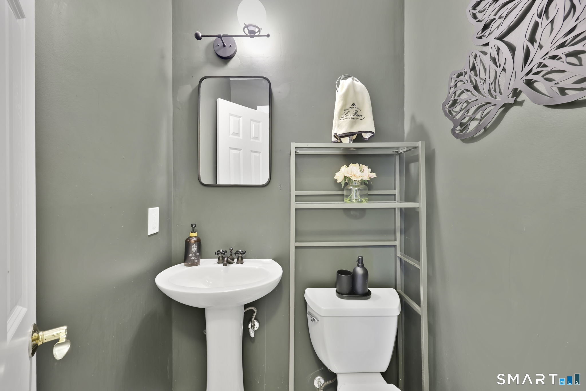 8 Whirling Dun, Unit 8 Canton, CT 06019 - Photo 10 of 28 a bathroom with a sink and a mirror