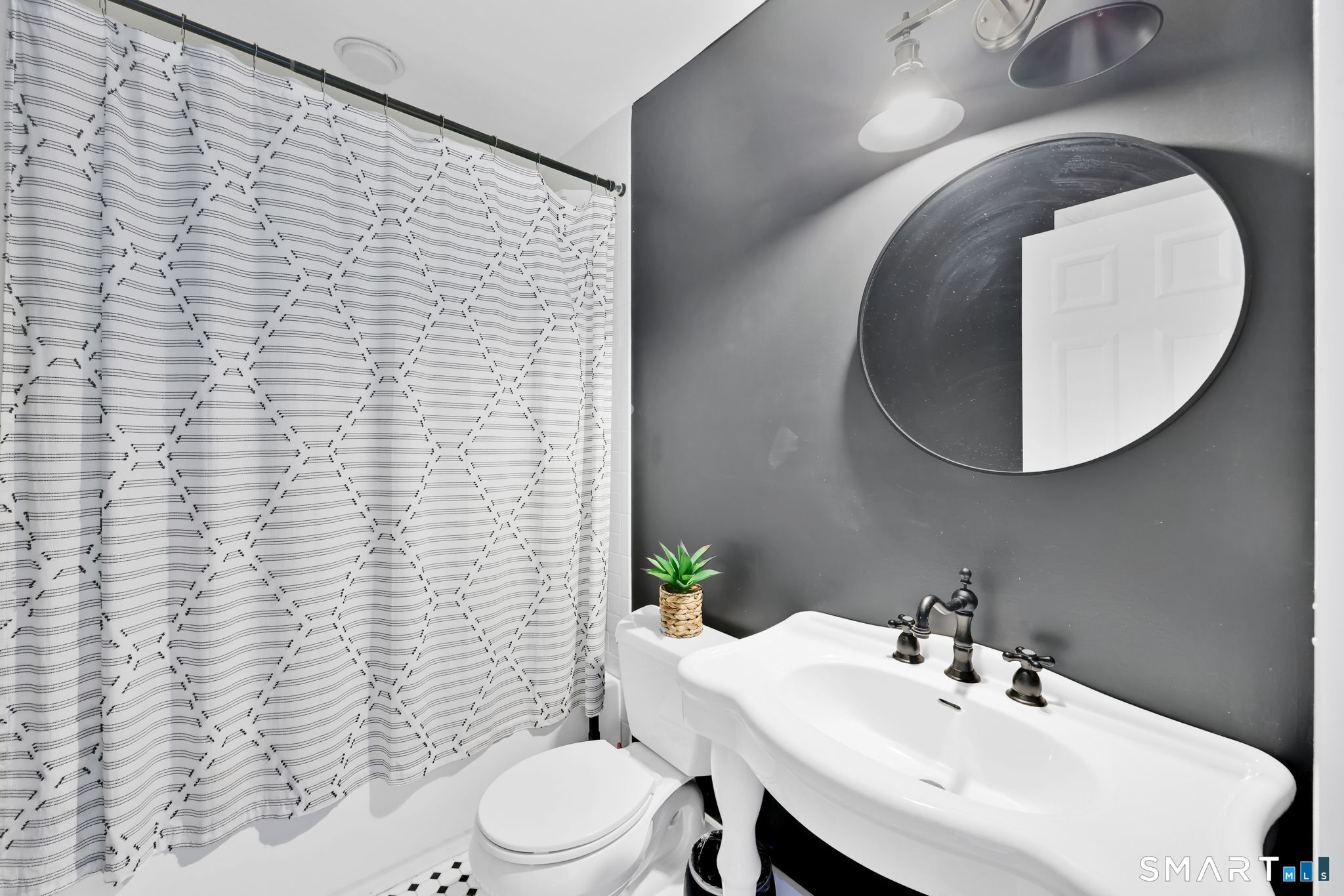 8 Whirling Dun, Unit 8 Canton, CT 06019 - Photo 17 of 28 a bathroom with a sink a toilet and mirror