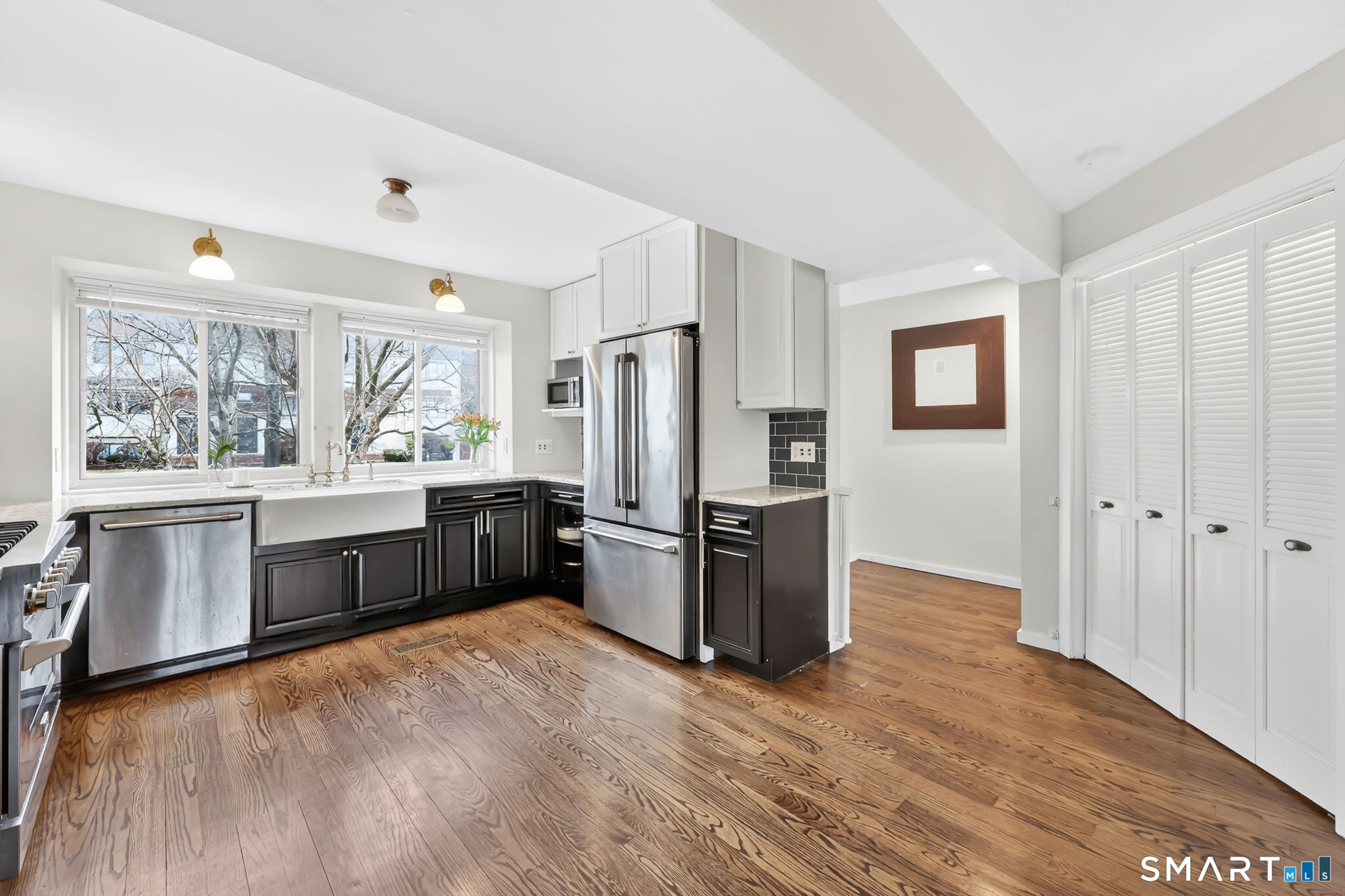 8 Whirling Dun, Unit 8 Canton, CT 06019 - Photo 5 of 28 a kitchen with stainless steel appliances a refrigerator and wooden cabinets