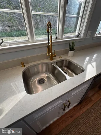 a bathroom with a sink mirror and a toilet
