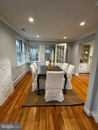 a large kitchen with a table and chairs