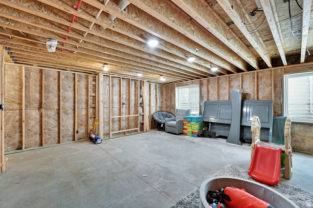 2777 West 4175th Street South, Unit 232 Roy, UT 84067 - Photo 25 of 27 Unfinished basement space featuring framing, concrete flooring, and multiple windows for natural light