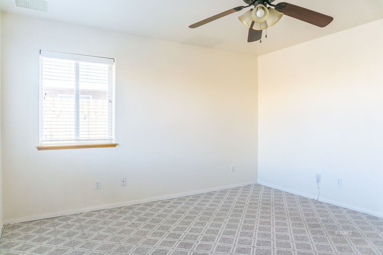 915 Sims Street Ridgecrest, CA 93555 - Photo 25 of 37 an empty room with a window and a fan