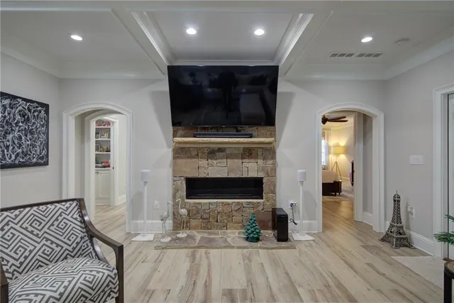 a living room with furniture a fireplace and a flat screen tv