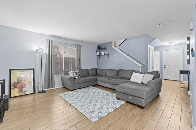 a living room with furniture and wooden floor