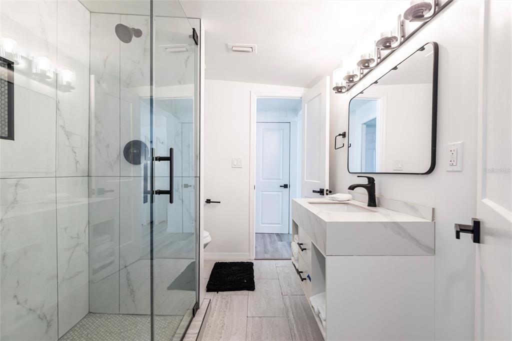 640 Broadway Street Longboat Key, FL 34228 - Photo 14 of 26 a bathroom with a sink a toilet and shower