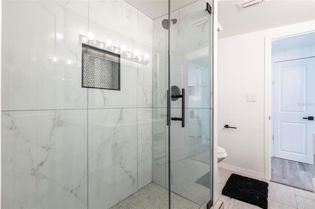 640 Broadway Street Longboat Key, FL 34228 - Photo 15 of 26 a bathroom with a shower and a mirror