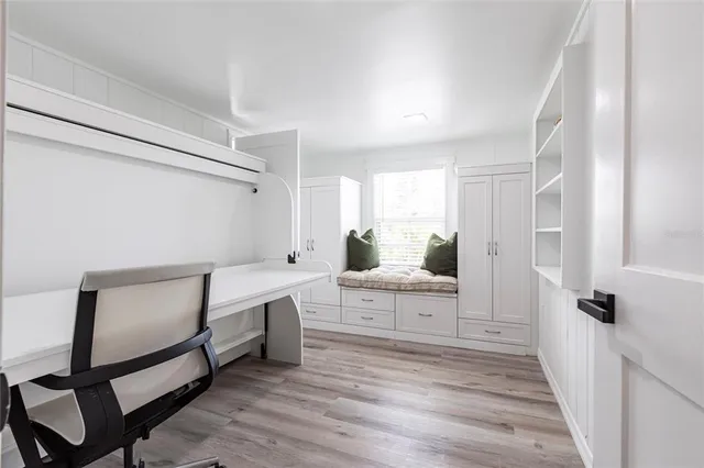 a view of a hallway with wooden floor and furniture
