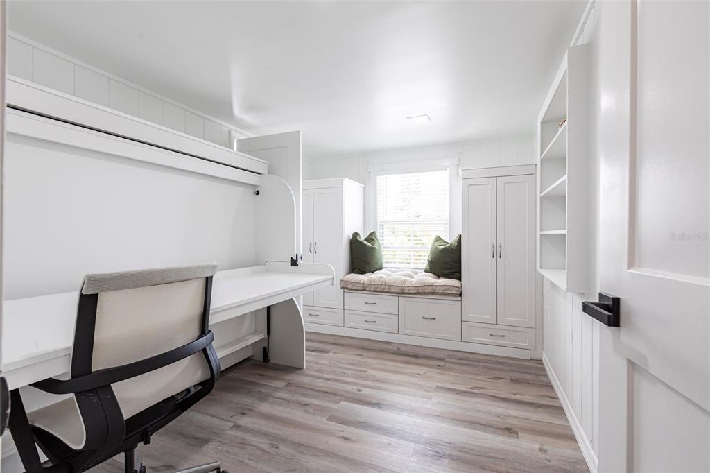 640 Broadway Street Longboat Key, FL 34228 - Photo 16 of 26 a view of a hallway with wooden floor and furniture
