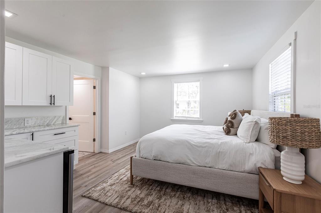 640 Broadway Street Longboat Key, FL 34228 - Photo 18 of 26 a bedroom with a large bed and wooden floor