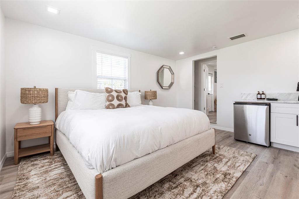 640 Broadway Street Longboat Key, FL 34228 - Photo 20 of 26 a bedroom with a bed and a chandelier