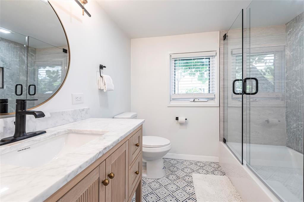 640 Broadway Street Longboat Key, FL 34228 - Photo 23 of 26 a bathroom with a sink a toilet and a mirror