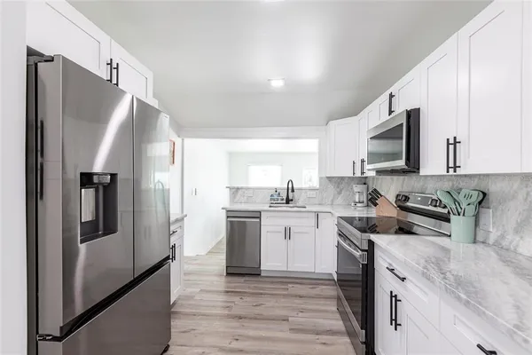 a kitchen with a sink stove and refrigerator