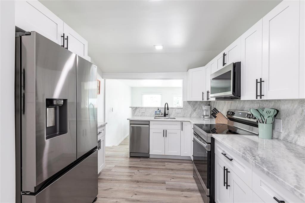 640 Broadway Street Longboat Key, FL 34228 - Photo 4 of 26 a kitchen with a sink stove and refrigerator