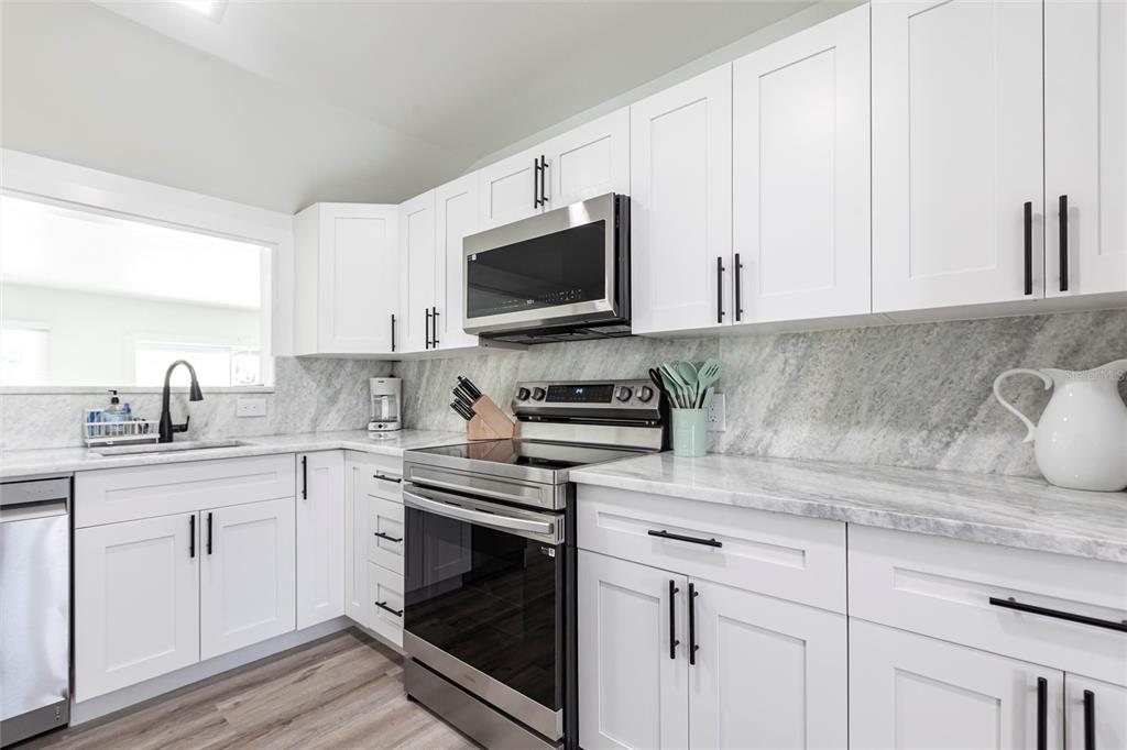 640 Broadway Street Longboat Key, FL 34228 - Photo 8 of 26 a kitchen with cabinets stainless steel appliances and a sink