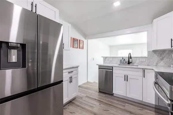a kitchen with stainless steel appliances a refrigerator and a sink
