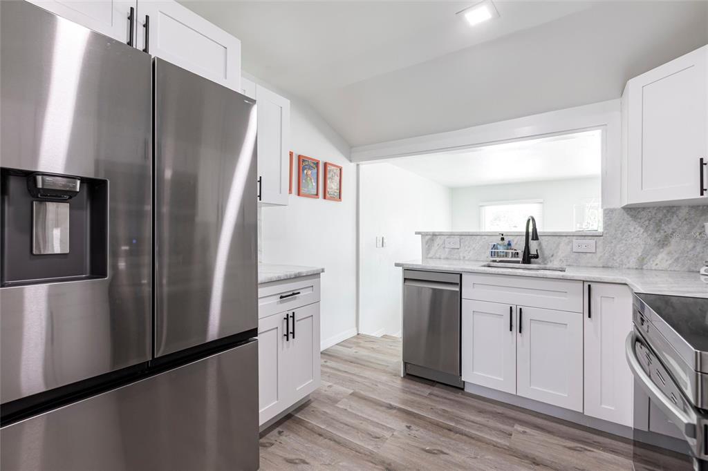 640 Broadway Street Longboat Key, FL 34228 - Photo 9 of 26 a kitchen with stainless steel appliances a refrigerator and a sink