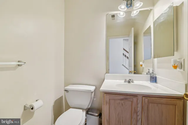 a bathroom with a sink a toilet a mirror and shower