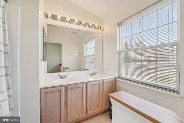 a bathroom with a sink a vanity and a mirror