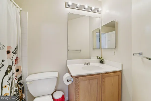 a bathroom with a sink a toilet and mirror