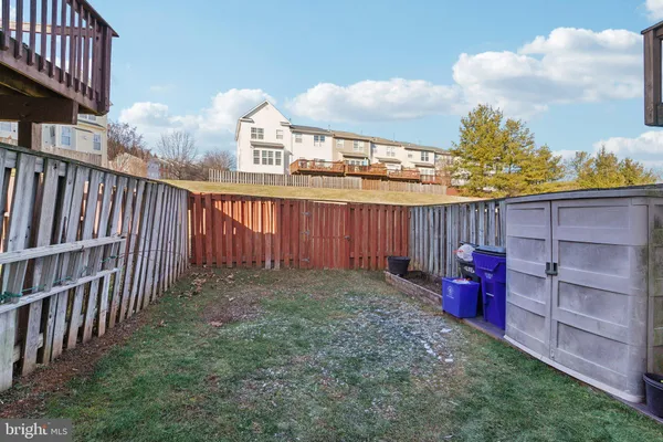 a view of a backyard with a wooden fence