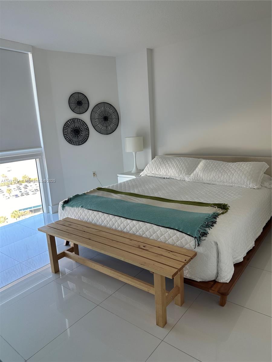 150 Sunny Isles Boulevard, Unit 11102 Sunny Isles Beach, FL 33160 - Photo 11 of 18 a room with furniture and window