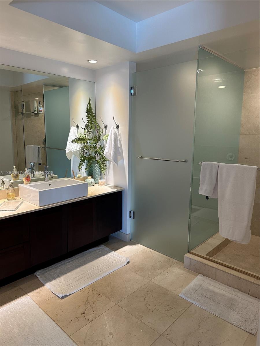 150 Sunny Isles Boulevard, Unit 11102 Sunny Isles Beach, FL 33160 - Photo 12 of 18 a bathroom with a sink and a mirror