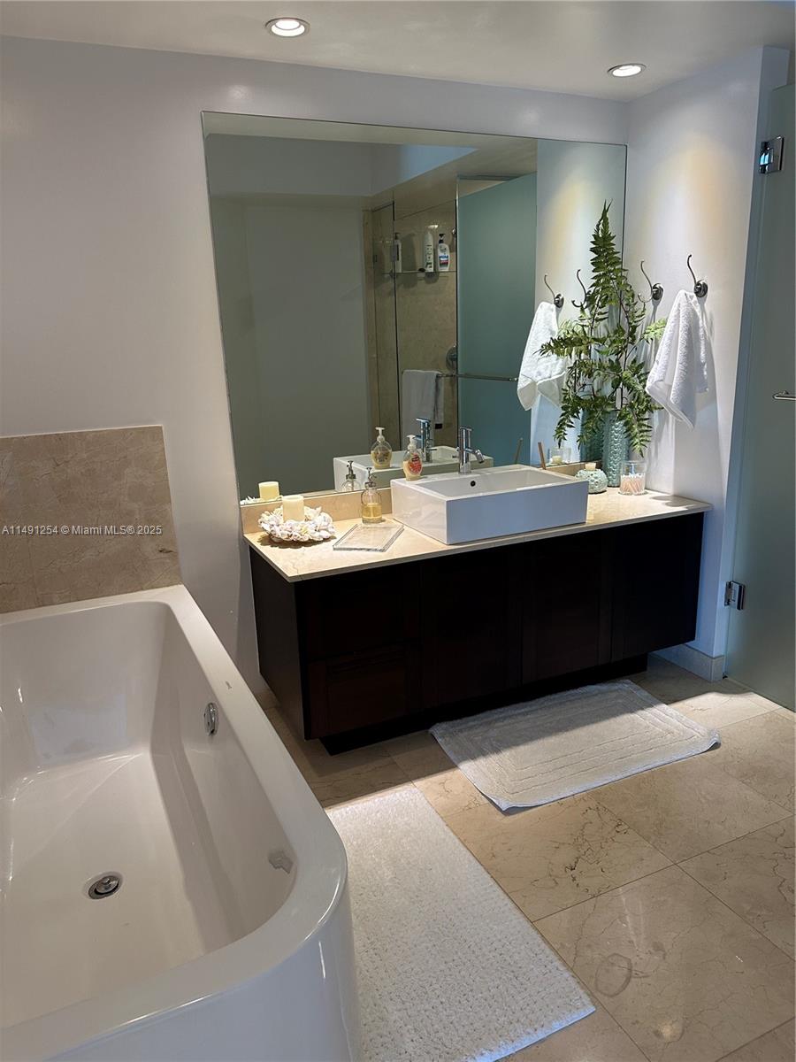 150 Sunny Isles Boulevard, Unit 11102 Sunny Isles Beach, FL 33160 - Photo 13 of 18 a bathroom with a sink and a bathtub