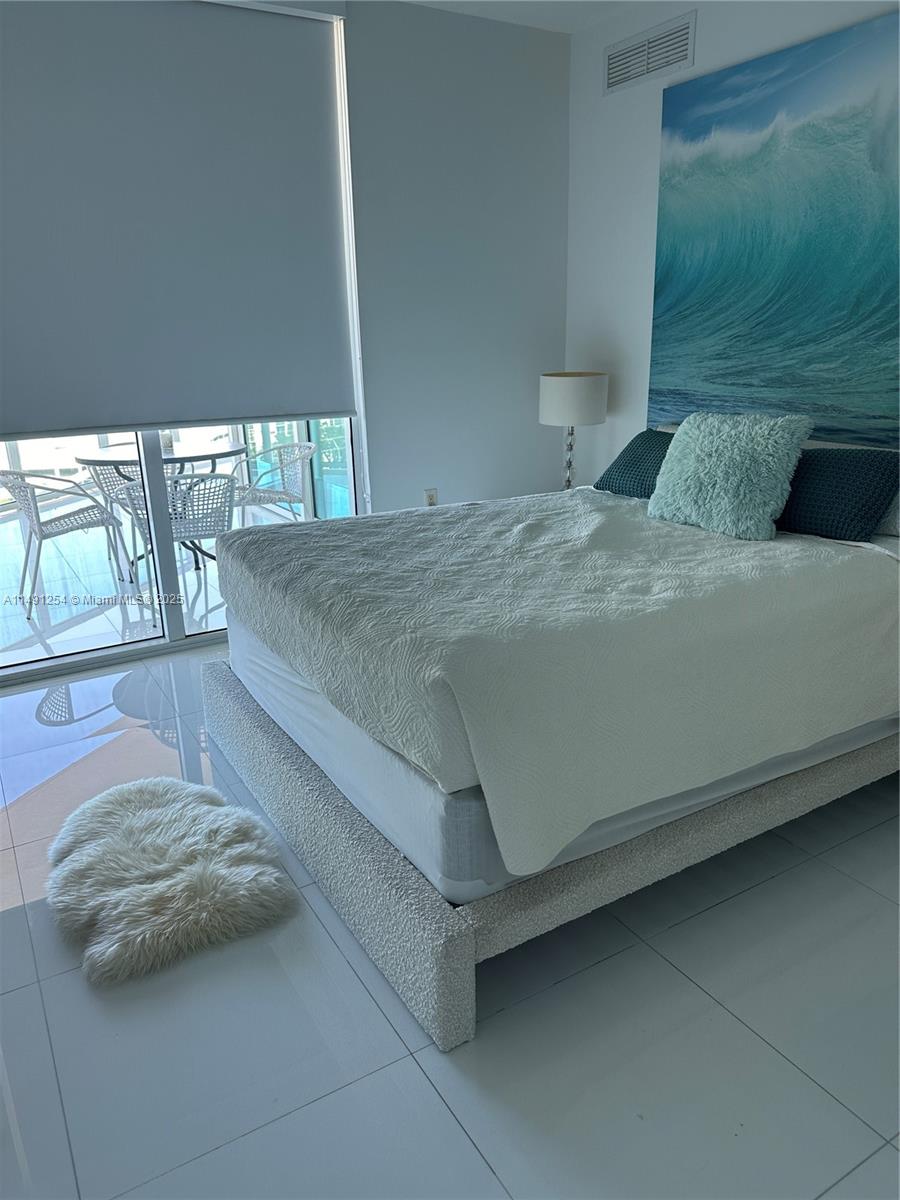 150 Sunny Isles Boulevard, Unit 11102 Sunny Isles Beach, FL 33160 - Photo 14 of 18 a bedroom with a bed and window