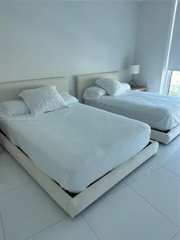 a bedroom with a bed and lamp