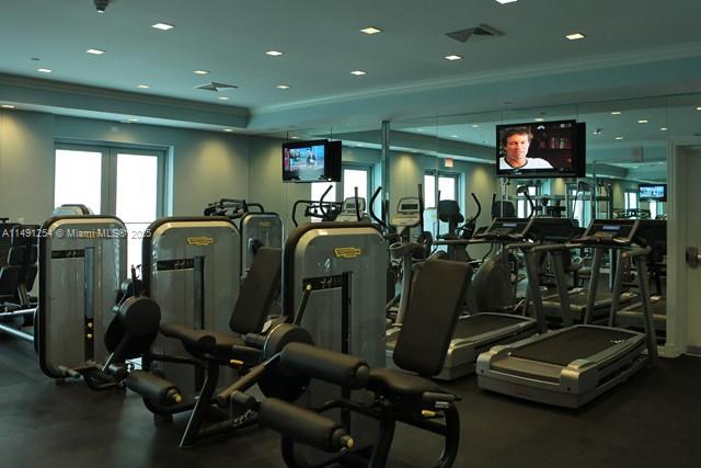 150 Sunny Isles Boulevard, Unit 11102 Sunny Isles Beach, FL 33160 - Photo 7 of 18 a room with gym equipment and a large window