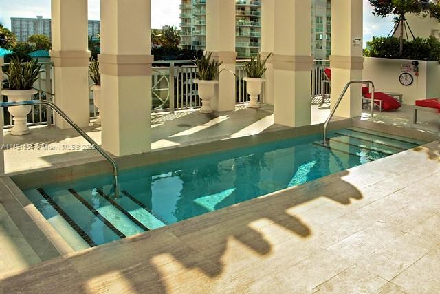 150 Sunny Isles Boulevard, Unit 11102 Sunny Isles Beach, FL 33160 - Photo 8 of 18 a view of a swimming pool with a patio