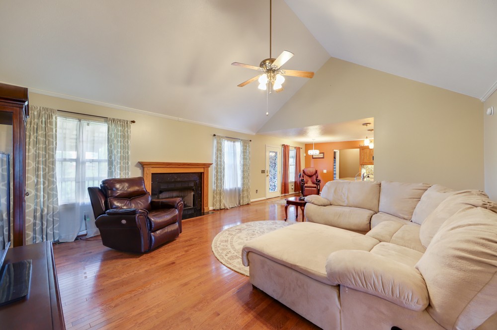 1303 Abiff Road Bon Aqua, TN 37025 - Photo 11 of 50 a living room with furniture a fireplace and a large window