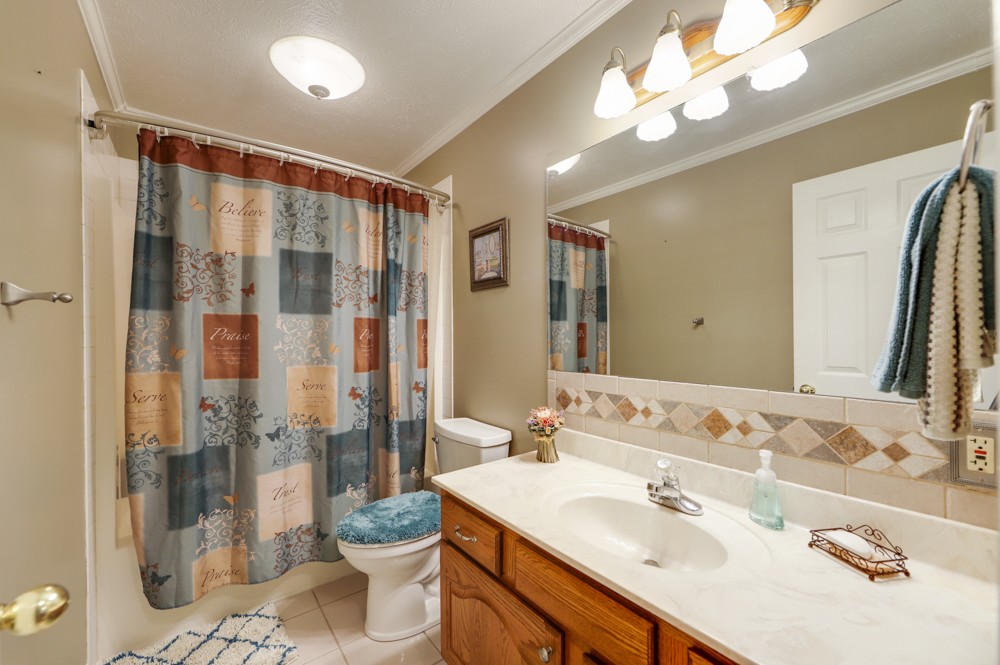1303 Abiff Road Bon Aqua, TN 37025 - Photo 26 of 50 a bathroom with a double vanity sink and a mirror