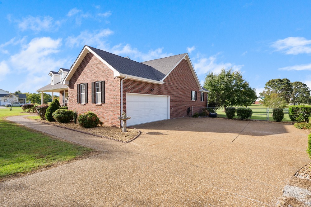 1303 Abiff Road Bon Aqua, TN 37025 - Photo 3 of 50 a front view of a house with a yard and garage